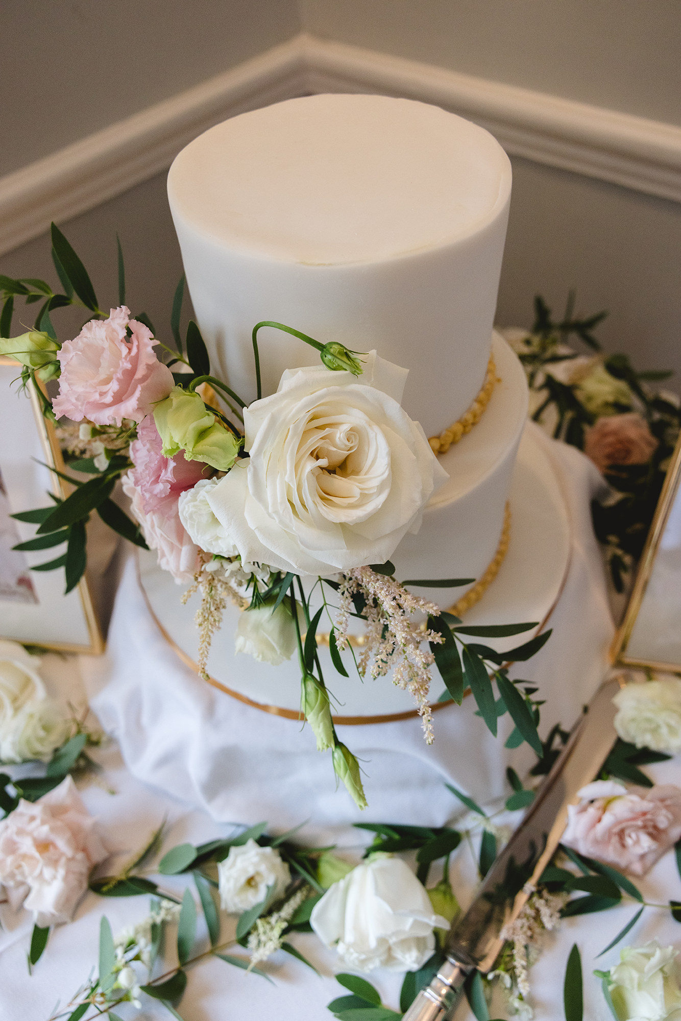 Fondant wedding cake with fresh flowers limerick
