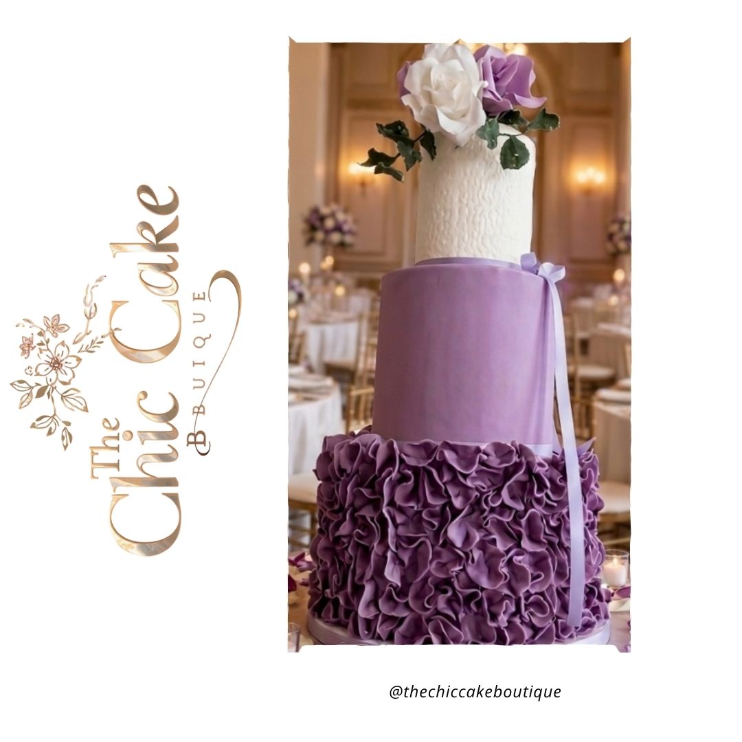 Luxurious 3 tier purple and white wedding cake with an intricate dark purple ruffled fondant bottom tier and lavender middle tier, setup in a grand hotel ballroom. This purple Ombre wedding cake with fondant ruffle and sugar flowers is made by the chic cake boutique serving Munster Ireland